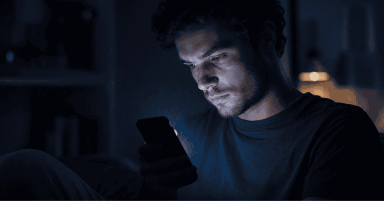 Digital distraction — a smartphone's glow illustrating how apps pull on the brain's reward system