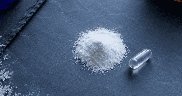 L-tyrosine for stress: amino-acid powder and capsule on a cold grey surface